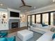 Bright and airy living room boasts a fireplace, built-ins, and glass doors to patio at 3416 Edgemont Dr, Raleigh, NC 27612
