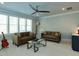 Living room featuring 2 couches, guitar, ceiling fan, and a glass coffee table at 3416 Edgemont Dr, Raleigh, NC 27612