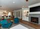 Open concept living room with kitchen, fireplace and hardwood floors at 3416 Edgemont Dr, Raleigh, NC 27612