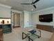 Living room featuring couches, a bar area with a mini fridge, tv, ceiling fan and a glass table at 3416 Edgemont Dr, Raleigh, NC 27612