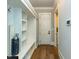 A mudroom with built in cubbies, seating, hooks, and wood floors at 3416 Edgemont Dr, Raleigh, NC 27612