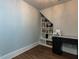 A home office with desk, built-in bookshelves, natural light, and wood floors at 3416 Edgemont Dr, Raleigh, NC 27612