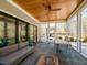 Covered patio featuring bluestone floors, ceiling fan, lounge chairs, dining table and access to the yard at 3416 Edgemont Dr, Raleigh, NC 27612