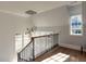 Bright foyer staircase boasts wood flooring, a modern chandelier, and large windows for ample natural light at 3416 Edgemont Dr, Raleigh, NC 27612