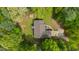 An aerial view of the property showcasing its roof, backyard deck, driveway, and landscaping at 3428 Hardwood Dr, Apex, NC 27539
