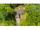 An aerial view of the home showcasing its well-manicured lawn and surrounded by mature trees at 3428 Hardwood Dr, Apex, NC 27539