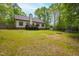 Expansive backyard with lush lawn, storage shed, trampoline and climbing structure at 3428 Hardwood Dr, Apex, NC 27539