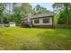 Spacious backyard with a well-maintained lawn, a deck, a storage shed, and a partial privacy fence at 3428 Hardwood Dr, Apex, NC 27539