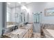 Elegant bathroom featuring double granite vanity, decorative mirrors, and luxurious bathtub at 3428 Hardwood Dr, Apex, NC 27539