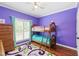 Cozy bedroom featuring bunk beds, wood floors, and a large window for natural light at 3428 Hardwood Dr, Apex, NC 27539