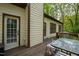 View of the back deck featuring an outdoor dining set and access to the home's interior at 3428 Hardwood Dr, Apex, NC 27539