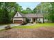 Charming home featuring a manicured lawn, beautiful landscaping, and a two-car garage at 3428 Hardwood Dr, Apex, NC 27539