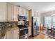 Kitchen with stainless steel appliances, granite countertops, and tile backsplash at 3428 Hardwood Dr, Apex, NC 27539