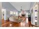 Cozy living room with a stone fireplace, hardwood floors, and plenty of natural light at 3428 Hardwood Dr, Apex, NC 27539