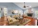 Inviting living room featuring a stone fireplace, hardwood floors, and comfortable seating at 3428 Hardwood Dr, Apex, NC 27539