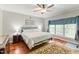 Serene bedroom featuring a ceiling fan, a large bed, and hardwood floors at 3428 Hardwood Dr, Apex, NC 27539