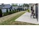 Grassy backyard with a patio area and a view of the neighborhood at 37 Blue Spruce Cir, Clayton, NC 27527