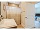 Bathroom featuring a shower/tub and a white door at 37 Blue Spruce Cir, Clayton, NC 27527