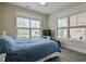 Bedroom featuring a queen bed, two windows and neutral walls at 37 Blue Spruce Cir, Clayton, NC 27527