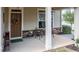 Charming covered porch with seating, front door with wreath, and stone accents at 37 Blue Spruce Cir, Clayton, NC 27527
