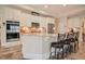Modern kitchen featuring white cabinets, granite countertops, stainless steel appliances, and stylish bar stools at 37 Blue Spruce Cir, Clayton, NC 27527