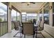 Relaxing screened porch with a ceiling fan and table with 6 chairs overlooking the well manicured backyard at 37 Blue Spruce Cir, Clayton, NC 27527