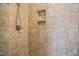 Shower featuring tan tile and built-in shelves at 37 Blue Spruce Cir, Clayton, NC 27527