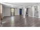 Finished basement featuring gray hardwood floors, a blue door, and ample space for various activities at 3713 Arrowwood Dr, Raleigh, NC 27604