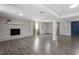 Spacious basement featuring gray hardwood flooring, a fireplace, and a doorway to another room at 3713 Arrowwood Dr, Raleigh, NC 27604