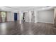 Finished basement with gray hardwood flooring, a staircase, and a functional laundry area at 3713 Arrowwood Dr, Raleigh, NC 27604