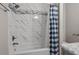 Stylish bathroom with modern fixtures, tiled shower and tub with blue shower curtain at 3713 Arrowwood Dr, Raleigh, NC 27604