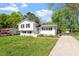 Inviting home exterior featuring a well-kept lawn, white facade, and ample parking space at 3713 Arrowwood Dr, Raleigh, NC 27604
