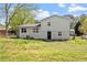 View of the home's exterior with a white facade and a spacious backyard area at 3713 Arrowwood Dr, Raleigh, NC 27604