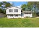 Charming two-story home with a freshly cut lawn and a mix of trees and sunlight at 3713 Arrowwood Dr, Raleigh, NC 27604