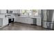 Open kitchen featuring stainless appliances, sleek white cabinetry and hardwood floors at 3713 Arrowwood Dr, Raleigh, NC 27604