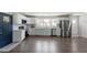 Open kitchen featuring stainless appliances, sleek white cabinetry and hardwood floors at 3713 Arrowwood Dr, Raleigh, NC 27604