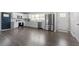 Open kitchen featuring stainless appliances, sleek white cabinetry and hardwood floors at 3713 Arrowwood Dr, Raleigh, NC 27604