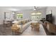 Inviting living room featuring a plush sectional sofa, stylish rug, and dining area with modern decor at 3713 Arrowwood Dr, Raleigh, NC 27604