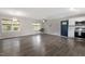 Open living room area flows into the bright kitchen with stainless appliances and hardwood floors at 3713 Arrowwood Dr, Raleigh, NC 27604