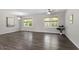 Spacious living room with wood-look floors, modern lighting, and ample natural light at 3713 Arrowwood Dr, Raleigh, NC 27604