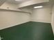 Spacious unfinished basement with green painted floors offers potential for customization and expansion at 409 Parkside Cir, Chapel Hill, NC 27516