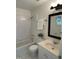 Bright bathroom featuring a shower-tub combo, white tile, a vanity, and a unique round window at 409 Parkside Cir, Chapel Hill, NC 27516