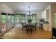 Light-filled dining area with a round wood table and comfortable seating, adjacent to a bright sunroom at 409 Parkside Cir, Chapel Hill, NC 27516