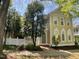 Beautiful two-story home with white picket fence, mature trees, and manicured landscaping at 409 Parkside Cir, Chapel Hill, NC 27516