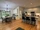 Open concept kitchen and dining area with stainless steel appliances, granite countertops and hardwood floors at 409 Parkside Cir, Chapel Hill, NC 27516