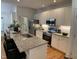 Bright kitchen features a granite island with seating, stainless steel appliances, and modern white cabinets at 409 Parkside Cir, Chapel Hill, NC 27516