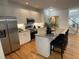 Contemporary kitchen with stainless steel appliances, granite countertops, and a spacious island with bar stools at 409 Parkside Cir, Chapel Hill, NC 27516