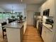 Bright and open kitchen with granite countertops, stainless steel appliances, and island seating open to the dining area at 409 Parkside Cir, Chapel Hill, NC 27516