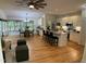 Spacious living area showcasing an open layout with hardwood floors, fireplace, kitchen, and dining area at 409 Parkside Cir, Chapel Hill, NC 27516