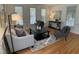 Comfortable living room featuring a neutral color palette, hardwood floors, and ample natural light from large windows at 409 Parkside Cir, Chapel Hill, NC 27516